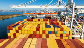 Cargo containers line a ship at the Port of Oakland on Wednesday, Aug. 6, 2025, in Oakland, Calif. (AP Photo/Noah Berger, File)