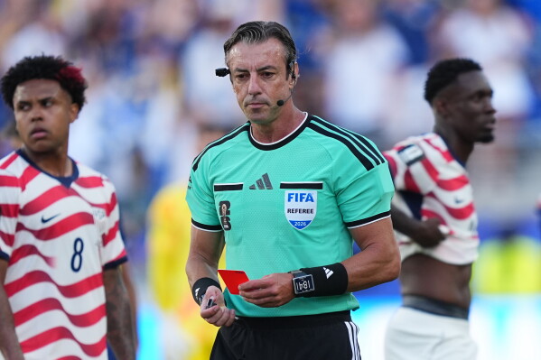 United States' Folarin Balogun, right, stands by after being issued a red card by Referee Raphael Claus, of Brazil, centre, as United States' Weston McKennie (8) looks on during the World Cup round of 32 soccer match between the United States and Bosnia in Santa Clara, Calif., near San Francisco, Wednesday, July 1, 2026. (AP Photo/Martin Meissner, File)