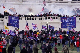 Rioters supporting President Donald Trump storm the Capitol in Washington, Jan. 6, 2021. (AP Photo/John Minchillo, File)