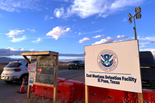 A sign marks the entrance to a series of hardened tents at the Camp East Montana immigrant detention center in the desert at a U.S. Army base on the outskirts of El Paso, Texas, Feb. 13, 2026. (AP Photo/Morgan Lee, File)