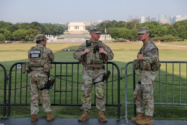 Member of the National Guard patrol at the base of the Washington Monument, Wednesday, July 15, 2026, in Washington. The Lincoln Memorial is in the background, (AP Photo/Rahmat Gul)