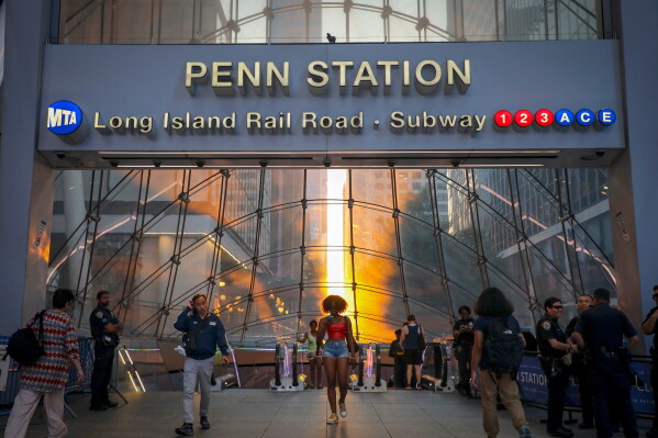 Commuters pass Penn Station and Madison Square Garden, July 2, 2026, in New York. (Photo by Andy Kropa/Invision/AP, File)