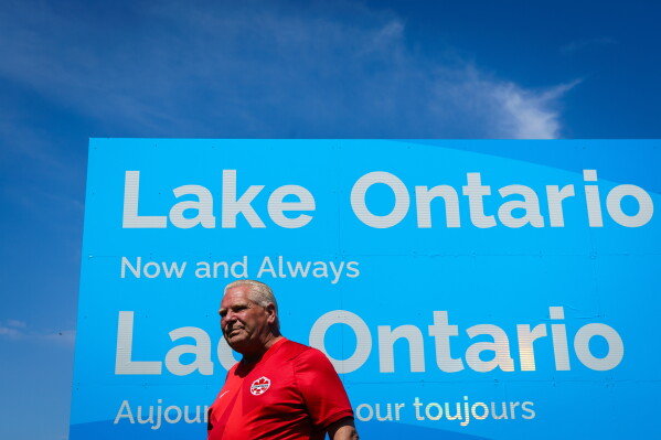 Ontario Premier Doug Ford unveils a sign for Lake Ontario at Fifty Point Conservation Area in Grimsby, Ontario, Canada, on Saturday, Aug. 29, 2026. (Keito Newman/The Canadian Press via AP)
