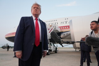 President Donald Trump speaks to reporters as he exits Air Force One at Joint Base Andrews, Md., after attending the World Cup final soccer match, Sunday, July 19, 2026. (AP Photo/Jacquelyn Martin)