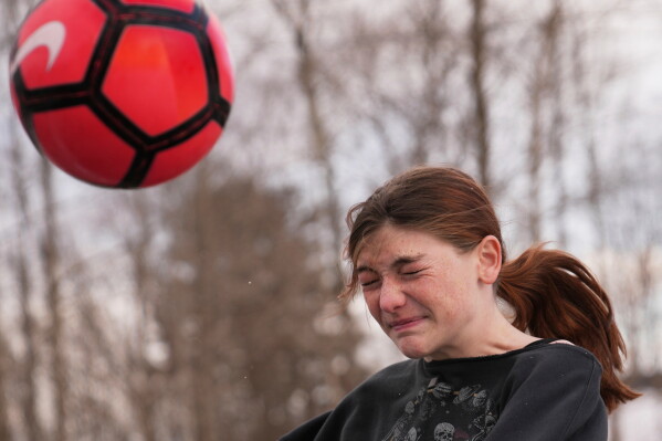 Parker Tirrell, a transgender athlete who plays on her high school's girls soccer team, heads the ball, Friday, March 7, 2025, in Plymouth, N.H. (AP Photo/Charles Krupa, File)