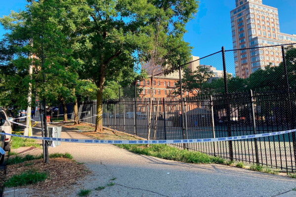 Crime scene tape surrounds the area on New York's Upper East Side, June 30, 2022, where police say a woman was fatally shot while she pushed her infant daughter in a stroller. (AP Photo/Jennifer Peltz, File)