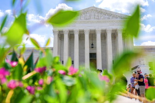 Visitors walk in front of the Supreme Court Friday, July 24, 2026, in Washington. (AP Photo/Mariam Zuhaib)