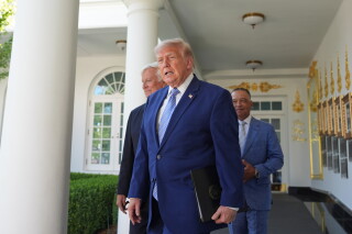 President Donald Trump arrives with Los Angeles Dodgers manager Dave Roberts and owner Mark Walter for an event to honor the 2025 World Series champions Los Angeles Dodgers in the Rose Garden of the White House, Thursday, July 23, 2026, in Washington. (AP Photo/Alex Brandon)
