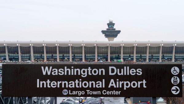 A sign of Washington Dulles International Airport station is seen during the opening of new Silver Line Extension at Washington Dulles International Airport, in Chantilly, Va., Nov. 15, 2022. (AP Photo/Jose Luis Magana, File)