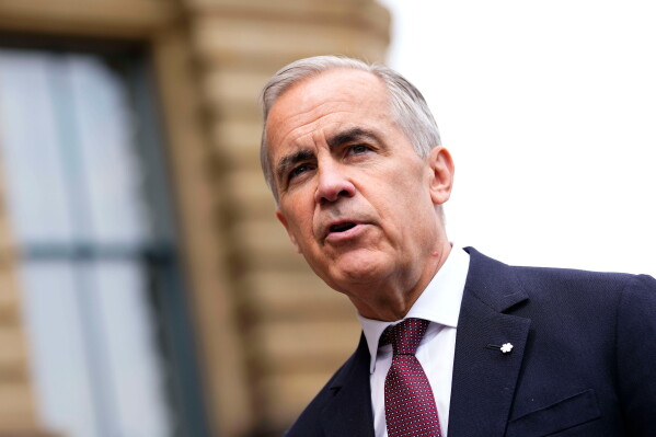 Prime Minister Mark Carney makes a statement outside the Office of the Prime Minister and Privy Council in Ottawa, on Tuesday, July 21, 2026. (Justin Tang/The Canadian Press via AP)