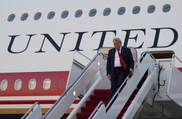 President Donald Trump exits Air Force One at Joint Base Andrews, Md., after attending the World Cup final soccer match, Sunday, July 19, 2026. (AP Photo/Jacquelyn Martin)